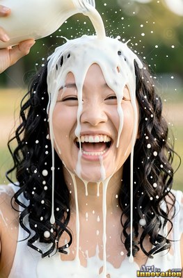 A woman laughs as thick milk is poured over her head in warm sunlight