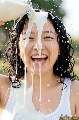 In a white tank top outdoors, a woman with a smile laughs as plain white milk pours directly over her face and black hair