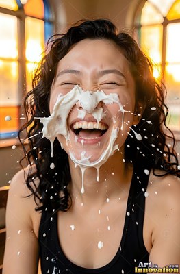 In front of warm windows, a woman in laughter ends up cream splashed on her face
