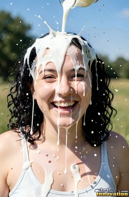 Curly dark hair frames a cheerful woman in a park as splashing white milk pours onto her head