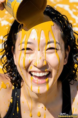 In bright sunlight, a woman laughing gets yellow paint poured over her face