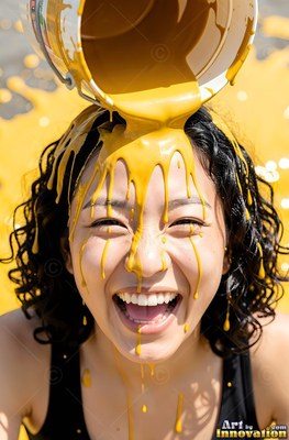 Woman smiling getting yellow paint poured over her head