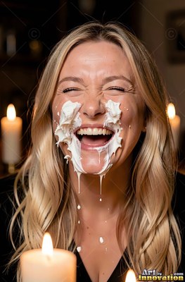 Blonde woman laughs with white cream splashed across her face