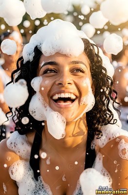 A woman giggles as thick white foam lands on her face in the warm sunlight