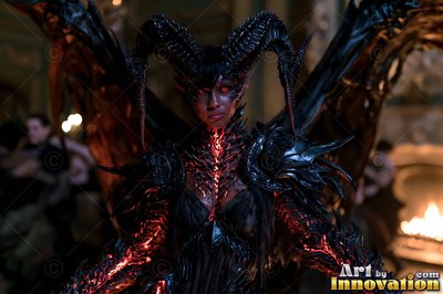 Standing by firelight, a woman with horns with wings wears black and red armor