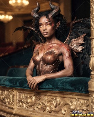 In a theater box, a horned Black woman with small wings leans on a railing