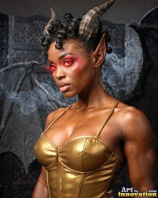 Looking aside, a horned woman in a gold corset stands with dark wings