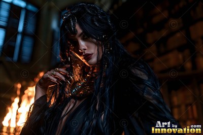 A wide gold collar circles a dark-haired woman near warm firelight in a dim room