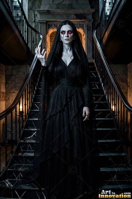 On a dark stone staircase, a woman with pale skin dressed in a black gown holds up one hand