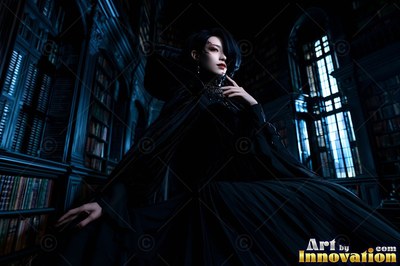 Woman in a black cape sitting in a dark library