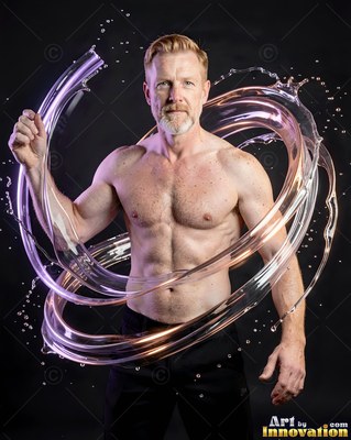 Facing forward in a dark studio, a shirtless man is encircled by clear water loops