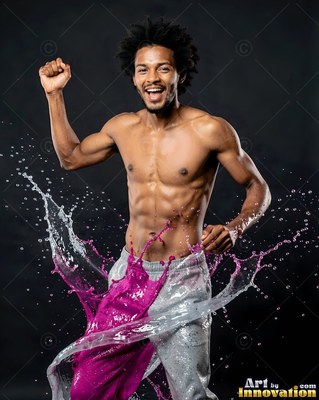 A man dances as splashes of bright magenta and clear water burst around his waist