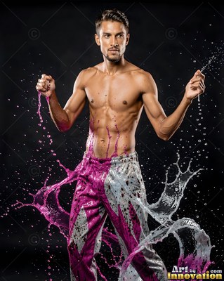 Posing shirtless, a man is splashed with pink and white water on dark background