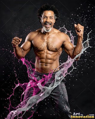 A shirtless muscular man flexes his arms as bright pink and white water splashes around him