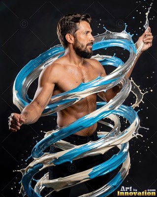 A shirtless bearded man poses in a dark studio wrapped in swirling blue and white paint swirls