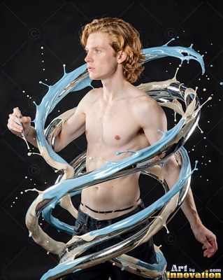 With wavy red hair in a dark studio, a shirtless man is looped by splashing blue paint