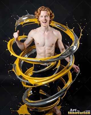 Red hair frames a smiling shirtless man ringed by swirling yellow and silver paint in a dark studio