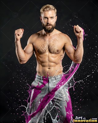 A shirtless bearded man flexes his arms as bright purple paint splashes over him