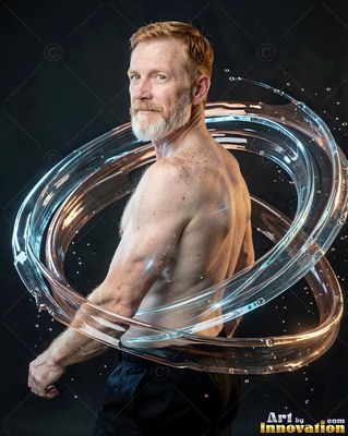 A neat white beard sets off a shirtless man in a dark studio encircled by clear water