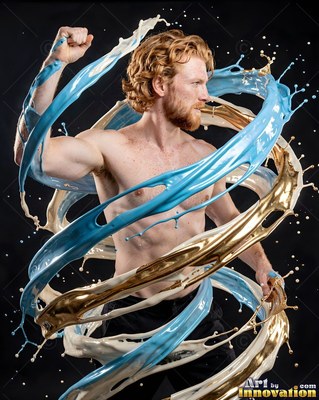 Red hair in a dark studio, where a shirtless man flexes inside swirls of blue and gold paint