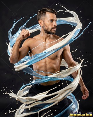 A shirtless man raises his fist as ribbons of white and blue liquid swirl around him