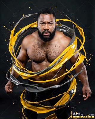 A bearded man stands as thick yellow and gray paint swirls around him