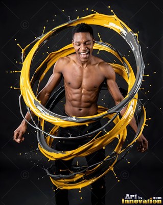 A smiling shirtless man circled by rings of yellow and gray paint