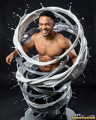 In a dark studio, a smiling shirtless man stands inside swirling rings of white paint