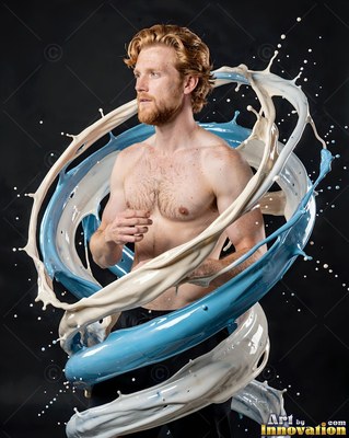 A shirtless red-haired man encircled by splashes of blue and cream liquid