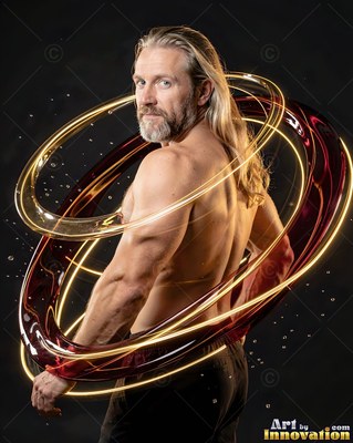 Looking back, a shirtless blond man is circled by loops of shiny gold and dark red liquid
