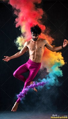 A shirtless man leaps midair in pink tights through a curve of red and blue powder smoke