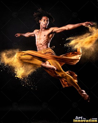 A shirtless man leaps in yellow pants as gold powder bursts around him