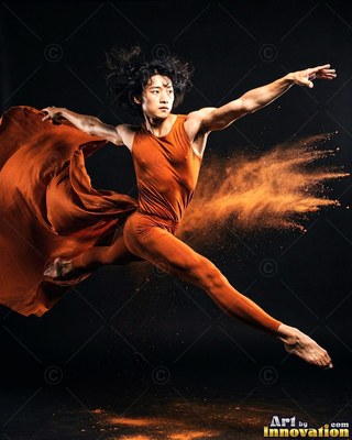 Wearing an orange leotard, a man leaps through orange powder across a dark studio