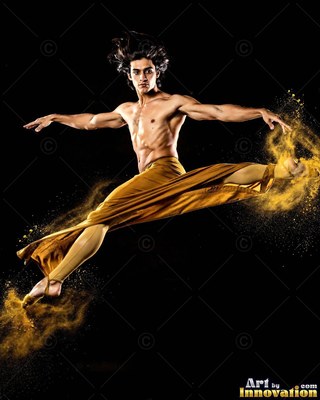 A shirtless man leaps in a split, trailing clouds of golden yellow powder
