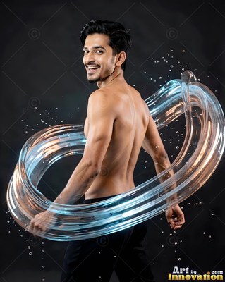 A shirtless smiling man stands in a dark studio wrapped in clear swirling water loops