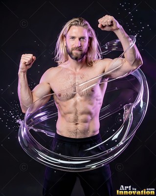 Long blond hair on a shirtless man in a dark studio, flexing his arms within a ring of water
