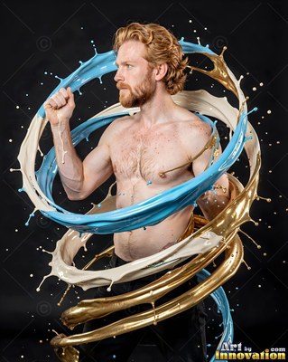 Turned sideways in a dark studio, a shirtless man is encircled by blue and gold splashes