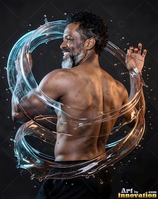 Turned away in a dark studio, a smiling man has swirling blue water around him