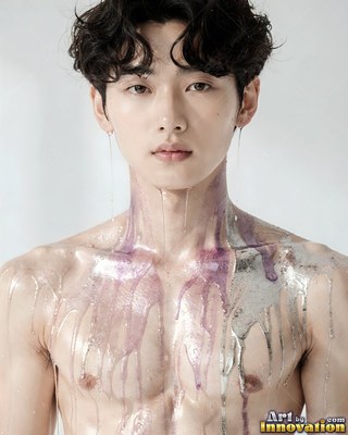 A shirtless young man with purple and silver liquid dripping down his chest