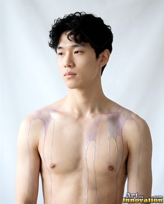 Shirtless man with pale purple liquid dripping down his chest