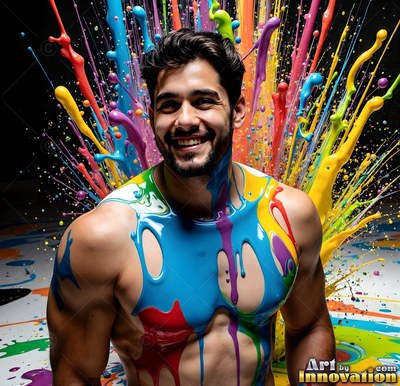 In a studio, a smiling shirtless man is covered in blue and yellow poured splashes of paint