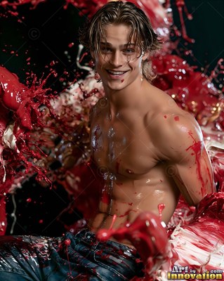 Leaning back in a dark studio, a shirtless man smiles through splashes of red paint