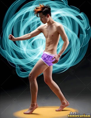 In purple shorts on a dark stage, a barefoot man steps through loops of bright blue light