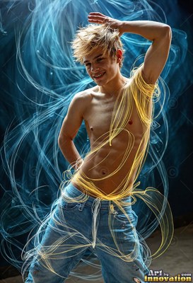 A smiling bare-chested young man poses in jeans as trails of yellow and blue light swirl around his torso