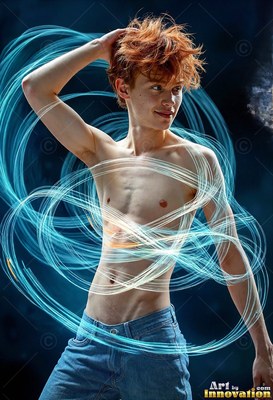 A shirtless young man touches his red hair as loops of bright blue light circle his torso