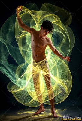 A barefoot man stands with one arm raised inside wide swirls of loops of yellow trails of light