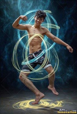 In a smoky dark studio, a barefoot man balances inside blue and trails of yellow light rings
