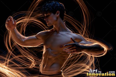 A shirtless man holds a dance pose surrounded by trails of warm light