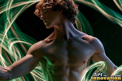 A bare-chested man turns his head behind green light trails