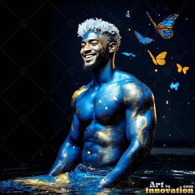 A shirtless man sits smiling in dark water covered in blue and gold body paint